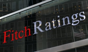 File photo of a flag reflected on the window of the Fitch Ratings headquarters in New York